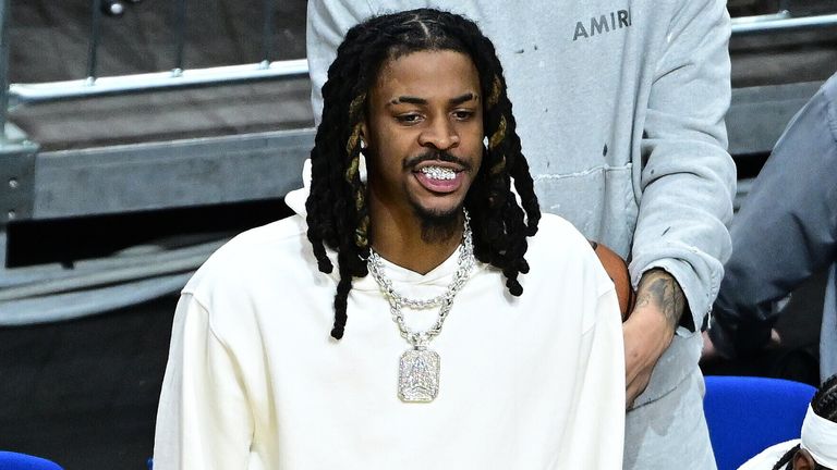 Morant stands and watches the action from courtside at the NBA Berlin Game (TimGroothuis/picture-alliance/dpa/AP Images)