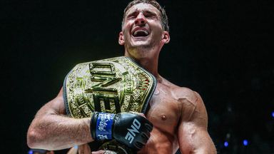 Nico Carrillo with the ONE interim featherweight Muay Thai world title belt