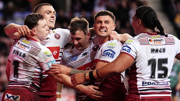 Wigan Warriors' Jai Field (left) celebrates scoring a try against Leigh