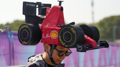 A fan wears a Ferrari-themed hat ahead of the Sprint Race of the Chinese Formula One Grand Prix at the Shanghai International Circuit, in Shanghai, China, Saturday, March 14, 2026. (AP Photo/Vincent Thian)