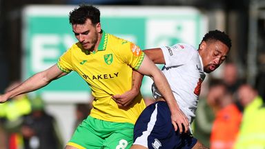 Daniel Jebbison of Preston North End competes for the ball with Liam Gibbs of Norwich City