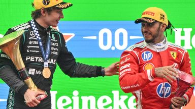 Winner Mercedes' Italian driver Kimi Antonelli (L) and third-placed Ferrari's British driver Lewis Hamilton (R) celebrate on the podium