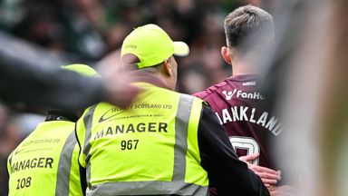 Hearts' Lawrence Shankland with stewards at full-time at Celtic Park
