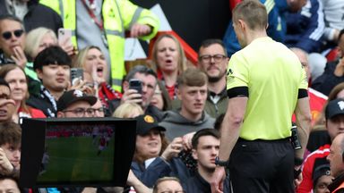 Referee Michael Salisbury consults the pitch-side monitor after being told by the VAR that there was a handball in the build-up to Man Utd's goal