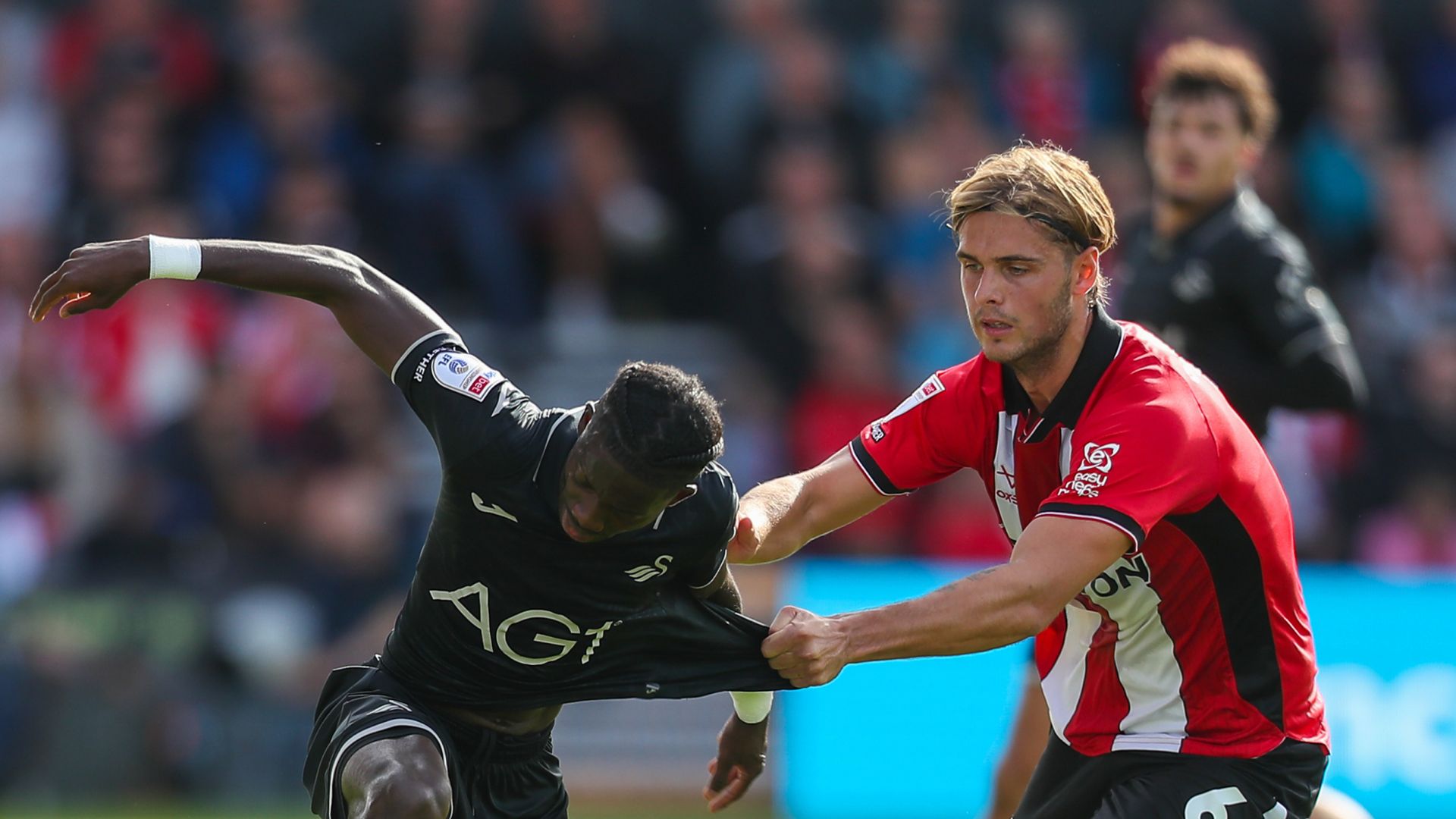 Swansea go top after victory at Lincoln