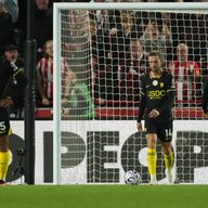 Chelsea players stand dejected after conceding the third goal against Brentford