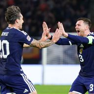 Kieron Bowie (L) celebrates his first Scotland goal with captain Andy Robertson